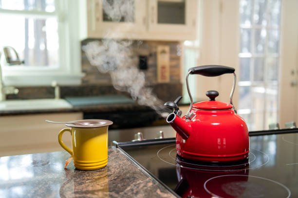 image with a red tea pot showing how to brew tea for beginners, step by step.